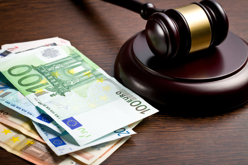 judge gavel with euro bills on wooden background